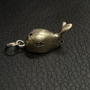Sterling Silver whale pendant with the fisherman inside.